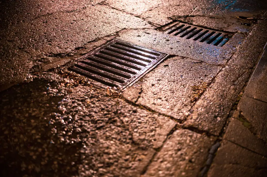 Drainage gully grate on a wet road in Hungerford, gully installation by The Drain Masters