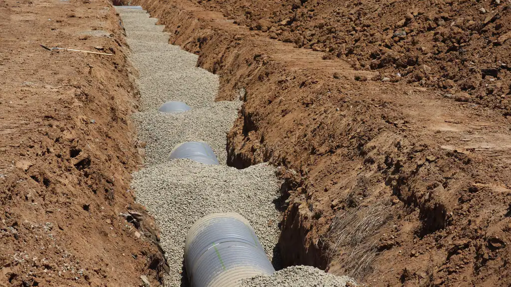 New drainage pipe laid in an excavated trench, drain repairs by The Drain Masters Swindon