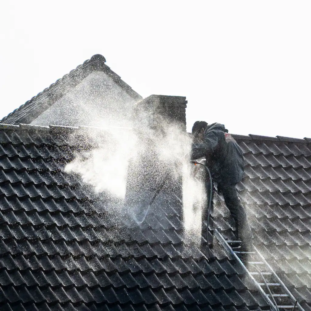 Roof being pressure cleaned to remove moss, roof cleaning by The Drain Masters