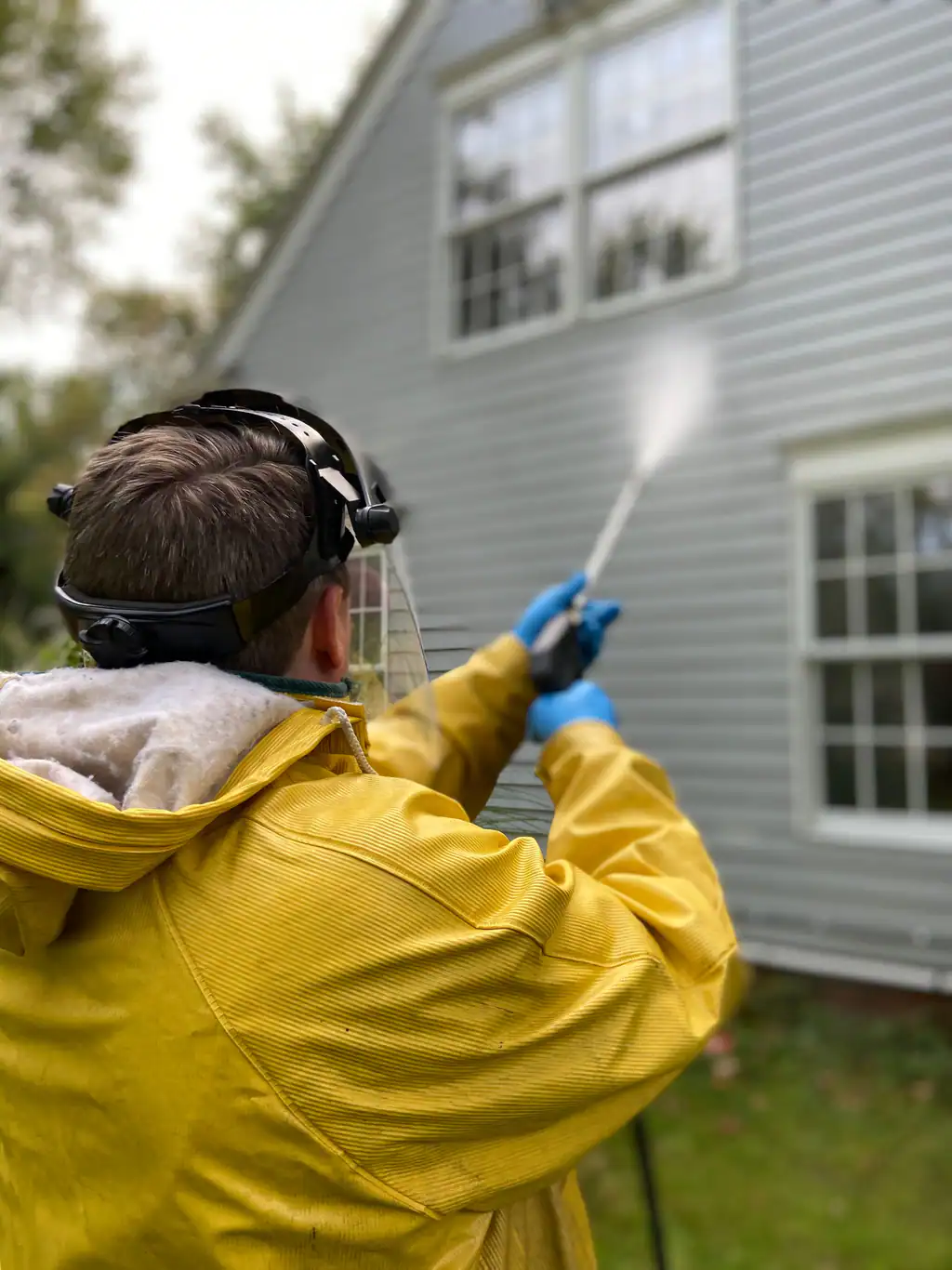 Exterior of a house being pressure washed, roof and exterior cleaning by The Drain Masters